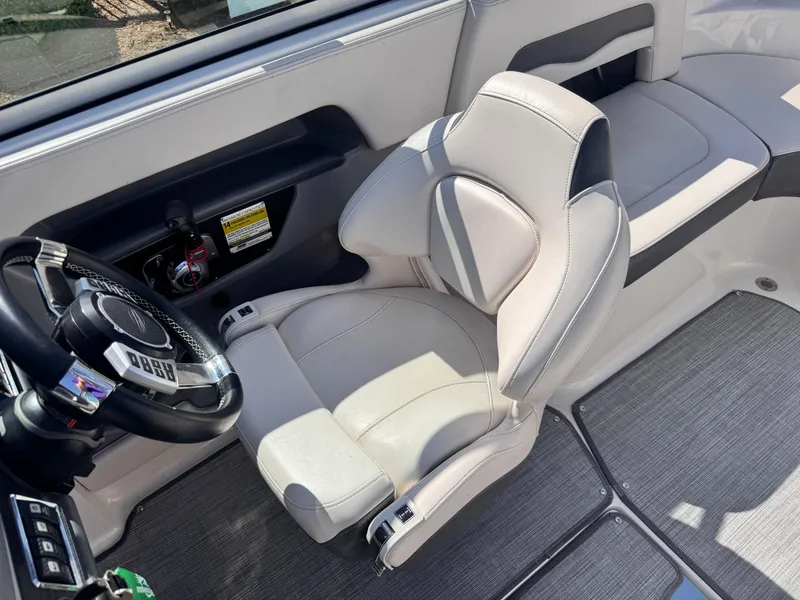 Slide: The Image of 2017 Chaparral 246 SSi boat interior with beige seating and gray flooring. - 17