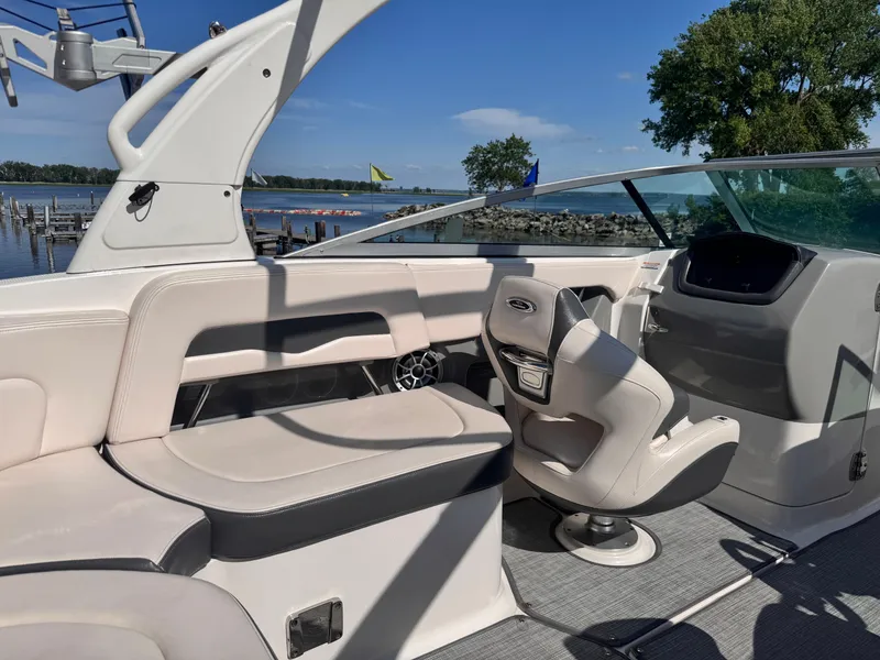 Slide: The Image of 2017 Chaparral 246 SSi boat interior with lake view and docked boats. - 20