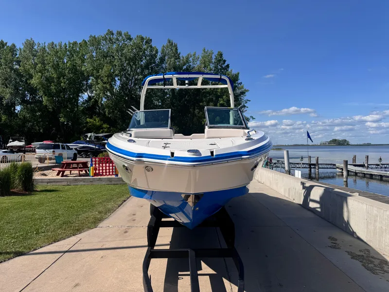 Slide: The Image of 2017 Chaparral 246 SSi boat on trailer, parked outdoors with trees in background. - 3