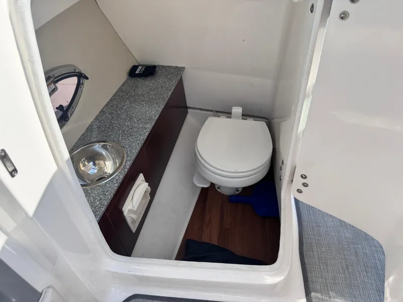 Slide: The Image of 2017 Chaparral 246 SSi boat ladder compartment with open hatch. - 30