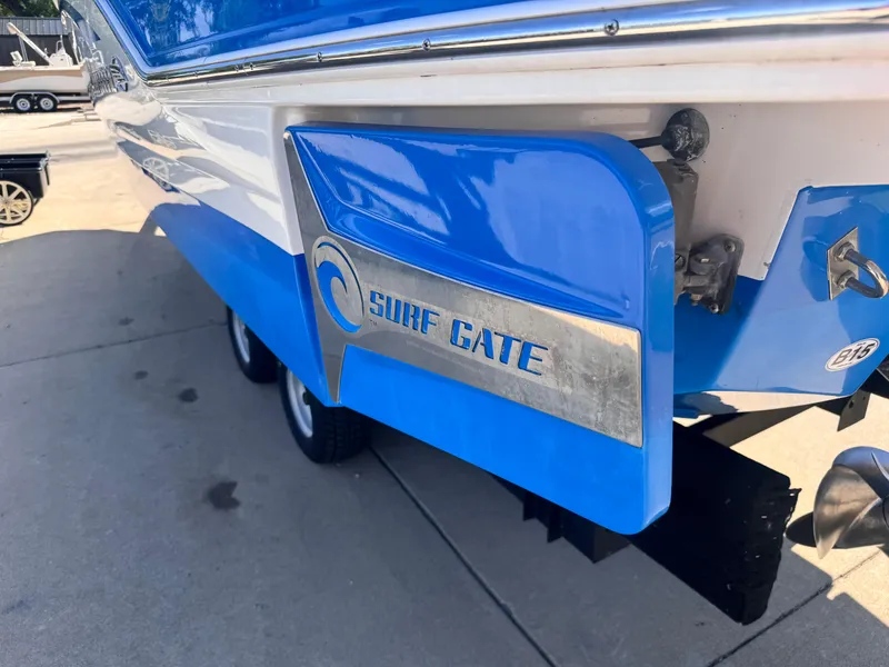 Slide: The Image of 2017 Chaparral 246 SSi boat on trailer, parked outdoors with trees in background. - 8