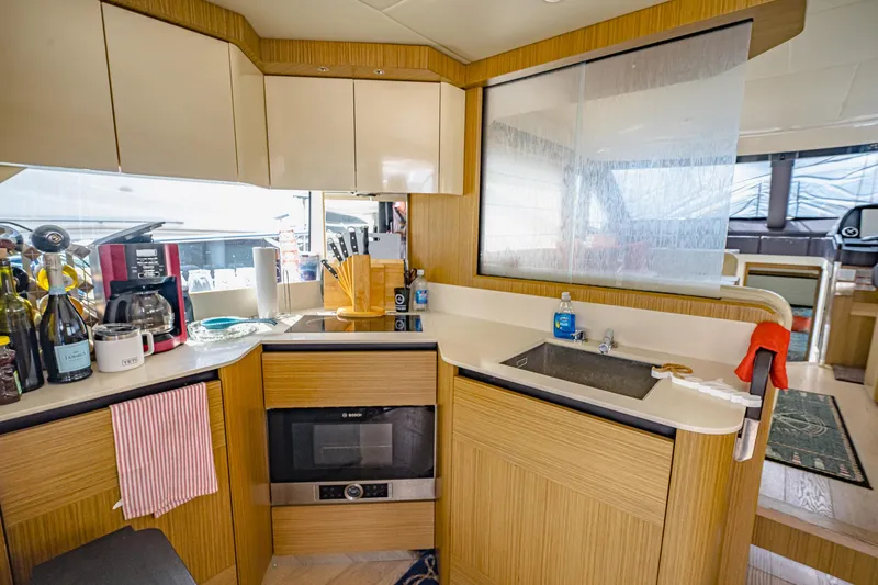 Slide: The Image of Modern kitchen in 2017 Absolute 50 Fly yacht with appliances and wooden cabinetry. - 21