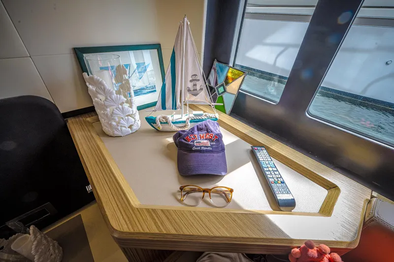 Slide: The Image of Cozy yacht interior with decor, remote, and cap on Absolute 50 Fly, 2017 model. - 26