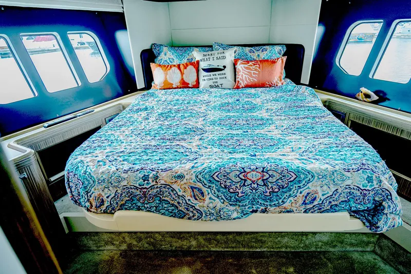 Slide: The Image of Luxurious bedroom interior of 2017 Absolute 50 Fly yacht with vibrant bedding and scenic windows. - 28