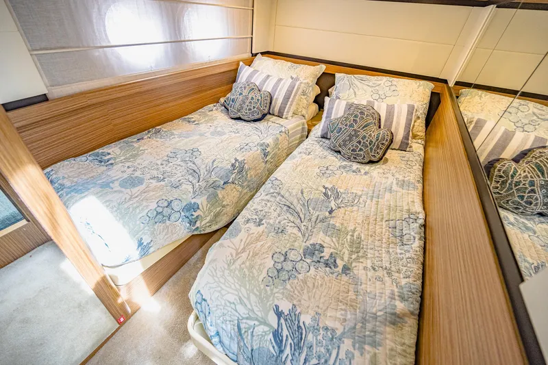 Slide: The Image of Luxurious twin beds in 2017 Absolute 50 Fly yacht cabin, featuring elegant bedding and wood accents. - 29