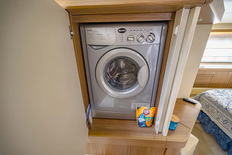 Slide: The Image of Washing machine in 2017 Absolute 50 Fly yacht interior, with detergent and fabric softener nearby. - 31