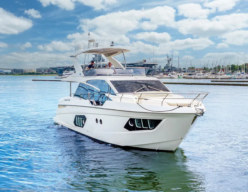 Slide: The Image of Luxury 2017 Absolute 50 Fly yacht cruising in a marina under a blue sky. - 41