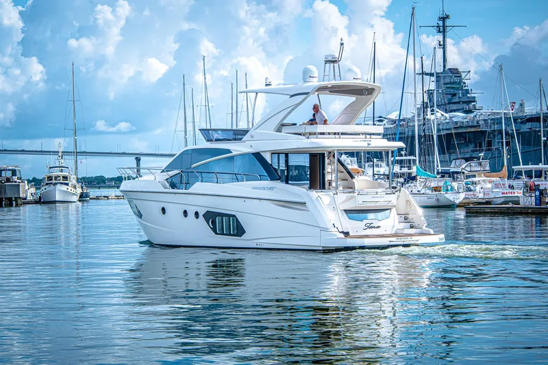 Slide: The Image of Luxury Absolute 50 Fly yacht from 2017 cruising in a scenic marina. - 43