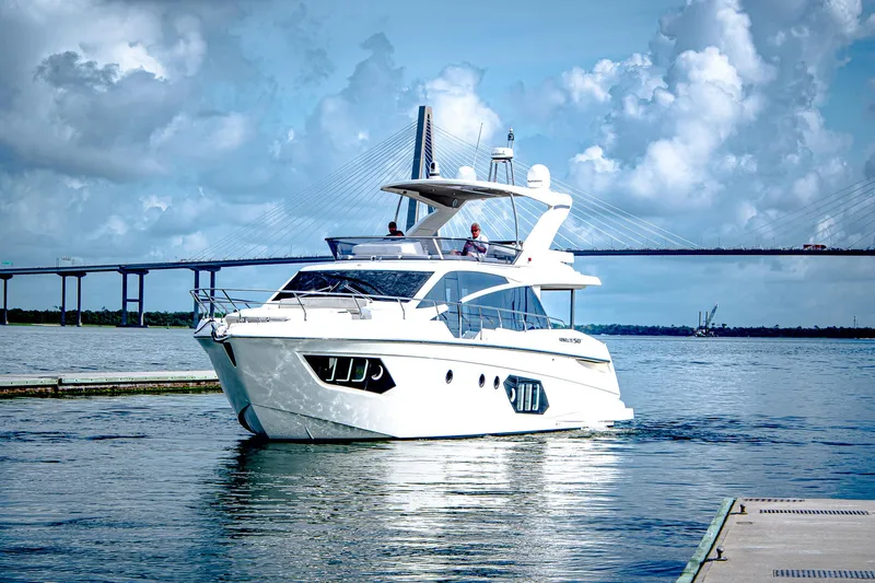 Slide: The Image of Luxurious 2017 Absolute 50 Fly yacht cruising near a bridge under a cloudy sky. - 44