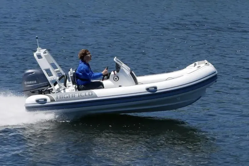 The Image of 2025 Highfield Sport 420 boat cruising on water with driver. - 0