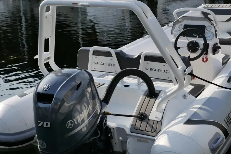 Slide: The Image of 2025 Highfield Sport 460 boat with Yamaha 70 engine, docked on calm water. - 3