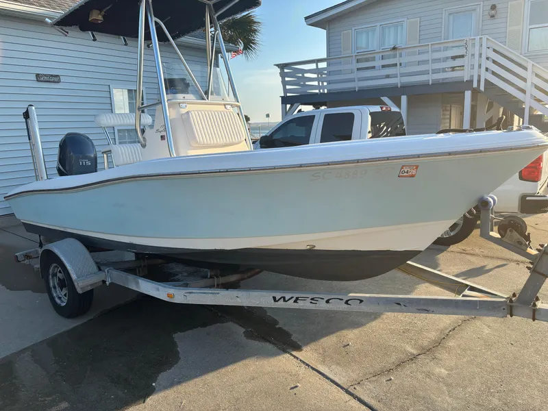 Slide: The Image of 2003 Pioneer 175 Bay Sport boat on trailer, parked near a house. - 1