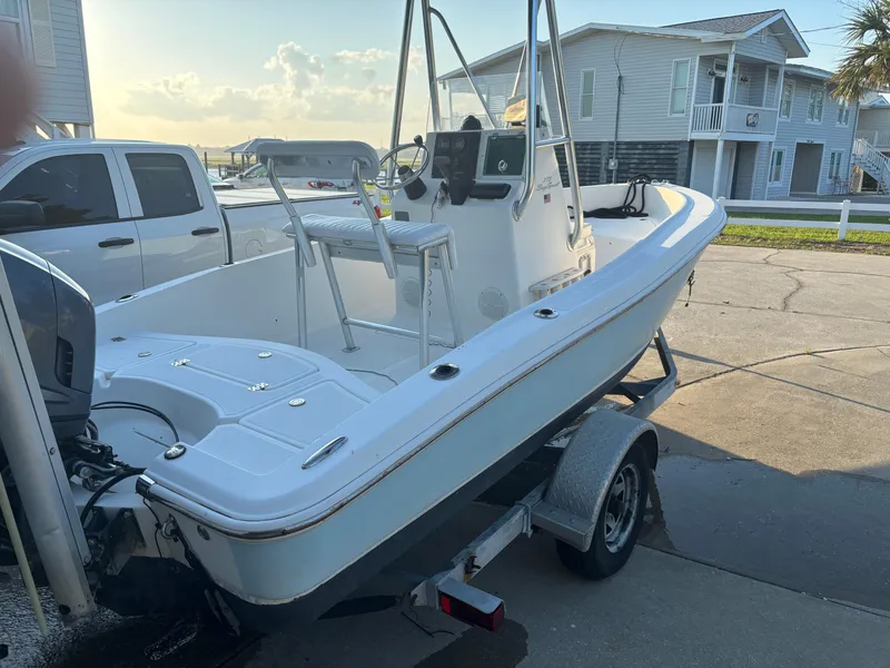 Slide: The Image of 2003 Pioneer 175 Bay Sport boat on trailer, parked near residential area. - 4