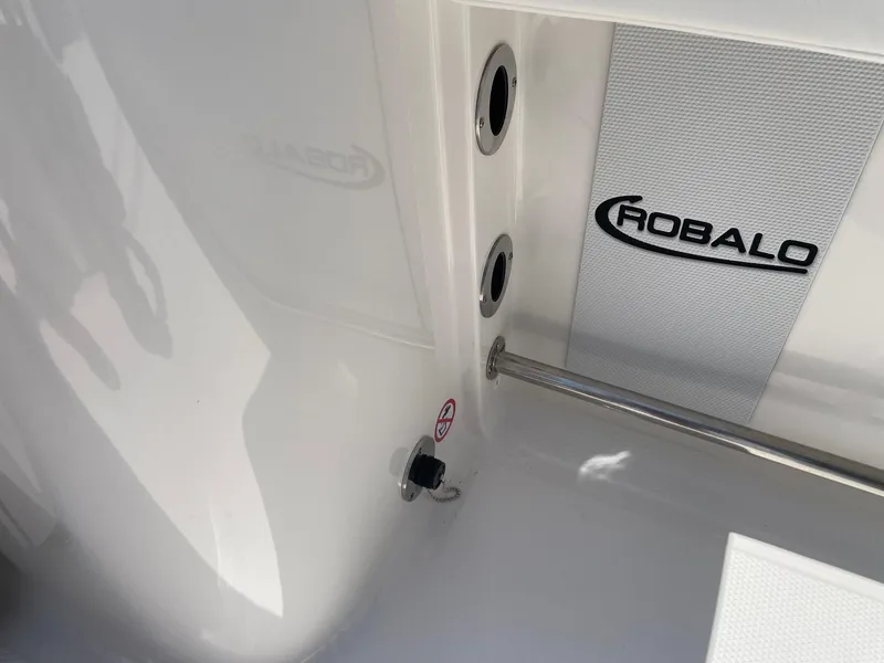 Slide: The Image of 2025 Robalo R230 Center Console interior detail with logo and fittings. - 11
