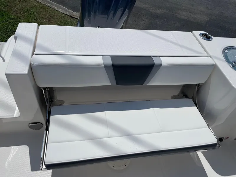 Slide: The Image of 2025 Robalo R230 Center Console boat seat, white upholstery, outdoor setting. - 8
