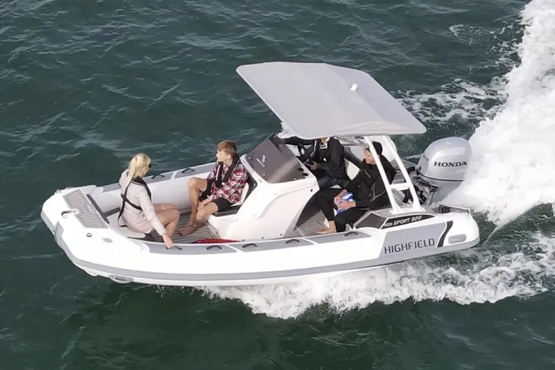 The Image of 2025 Highfield Sport 520 boat cruising on water with passengers. - 0
