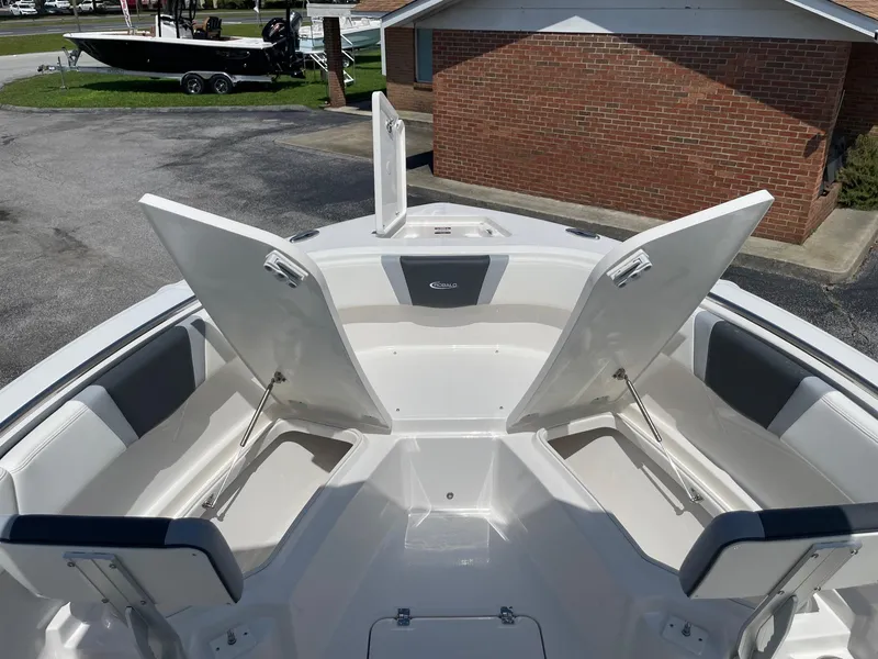 Slide: The Image of 2025 Robalo R230 Center Console boat with open storage compartments and seating. - 16