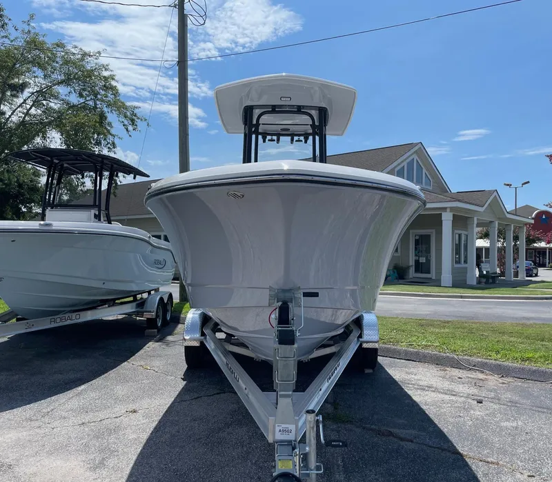 Slide: The Image of 2025 Robalo R230 Center Console boat on trailer, displayed outdoors under clear sky. - 3