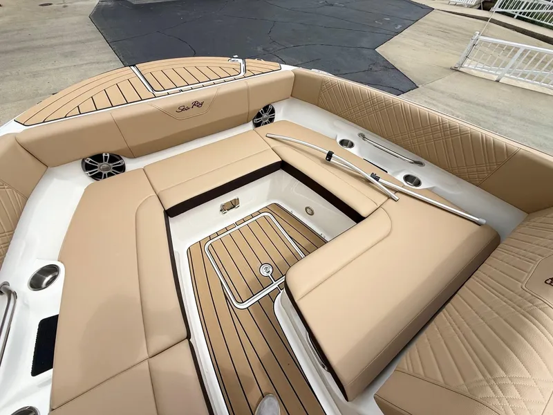 Slide: The Image of Luxurious interior of 2025 Sea Ray SDX 270 boat with tan seating and wood accents. - 11
