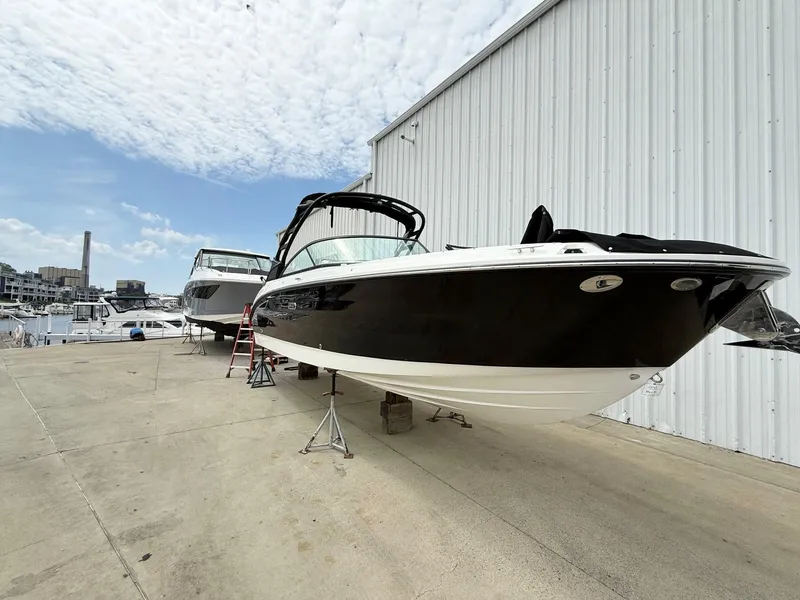 Slide: The Image of 2025 Sea Ray SDX 270 boat on dry dock near marina, clear sky background. - 3