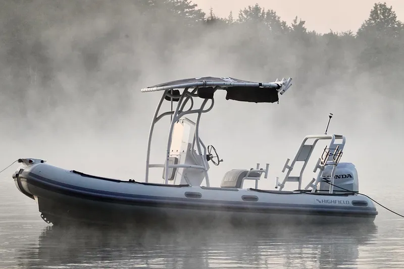 Slide: The Image of 2026 Highfield Patrol 540 boat in misty, calm waters. - 4