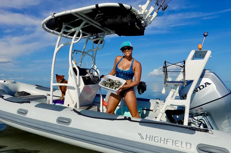 Slide: The Image of Woman on Highfield Patrol 540 boat with shells, 2026. - 5