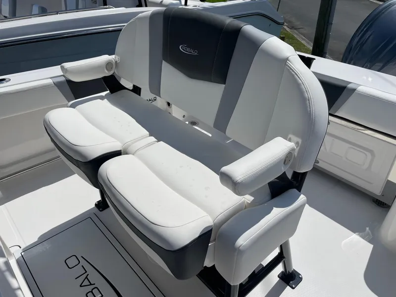 Slide: The Image of 2025 Robalo R230 Center Console boat seating, featuring white and gray cushioned seats with armrests. - 13