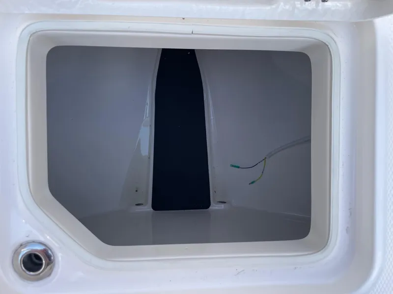 Slide: The Image of Storage compartment of 2025 Robalo R230 Center Console boat, featuring wiring details. - 21