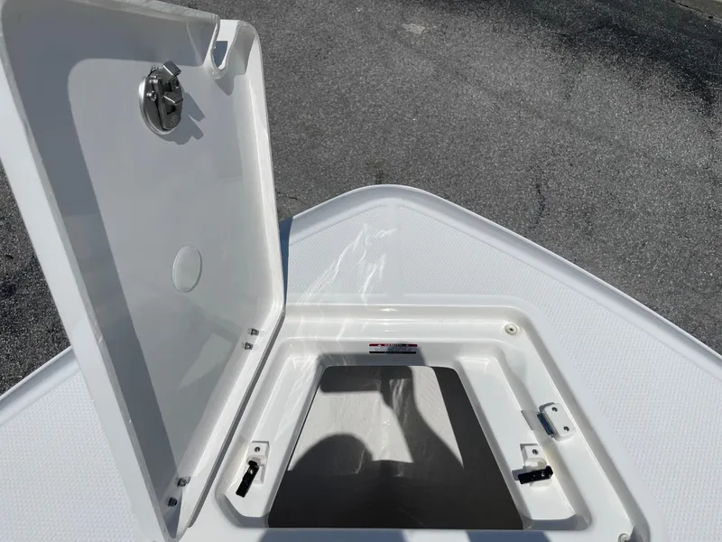Slide: The Image of Open storage compartment on 2025 Robalo R230 Center Console boat. - 22