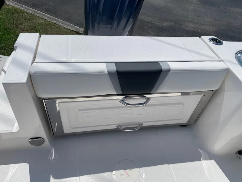 Slide: The Image of 2025 Robalo R230 Center Console boat seat and storage compartment. - 7