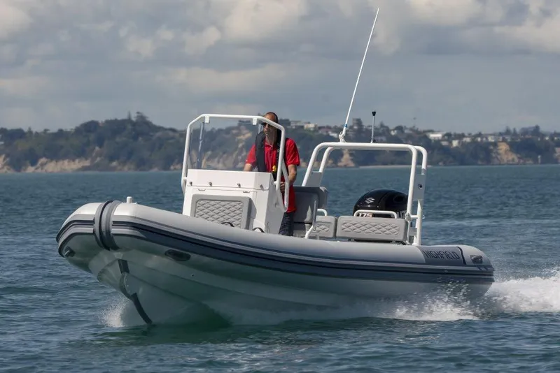 The Image of 2024 Highfield Patrol 600 boat cruising on a lake with two people onboard. - 0