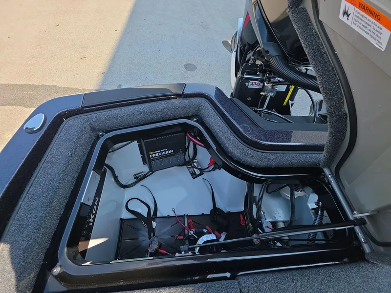 Slide: The Image of Open battery compartment of iKon LX21 boat, showcasing wiring and components, 2026 model. - 11