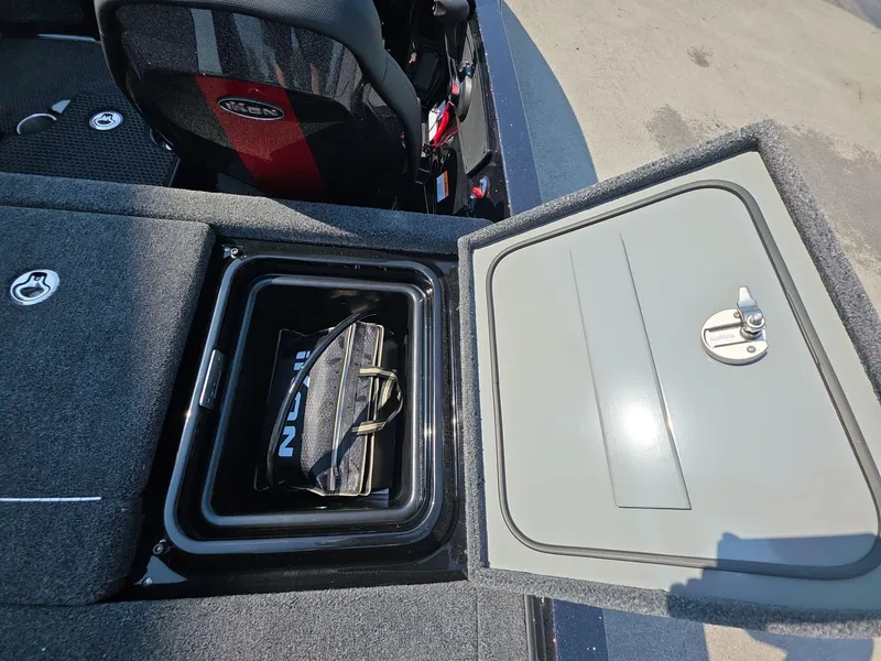 Slide: The Image of Open storage compartment in 2026 iKon LX21 boat with bag inside. - 12