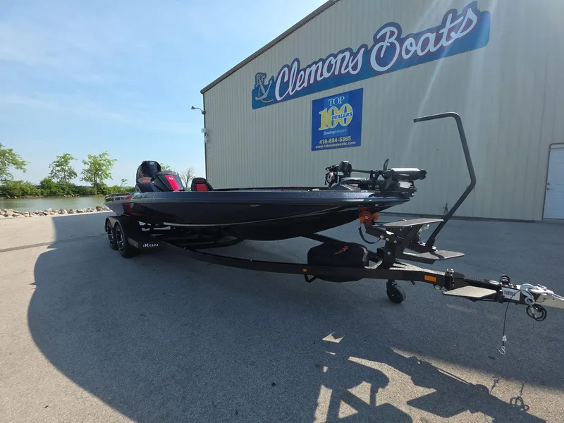 Slide: The Image of 2026 iKon LX21 boat on trailer outside Clemons Boats dealership. - 2