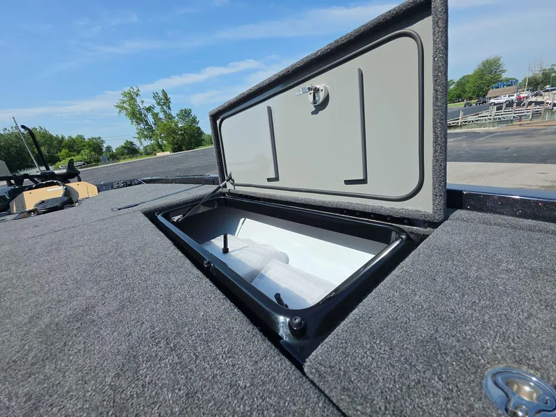 Slide: The Image of Open storage compartment on 2026 iKon LX21 boat, showcasing spacious interior and secure latch. - 21
