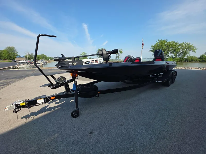 Slide: The Image of 2026 iKon LX21 boat on trailer by lakeside, clear sky background. - 3