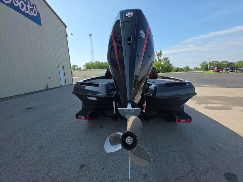 Slide: The Image of Rear view of 2026 iKon LX21 boat with powerful outboard motor in a parking lot. - 5