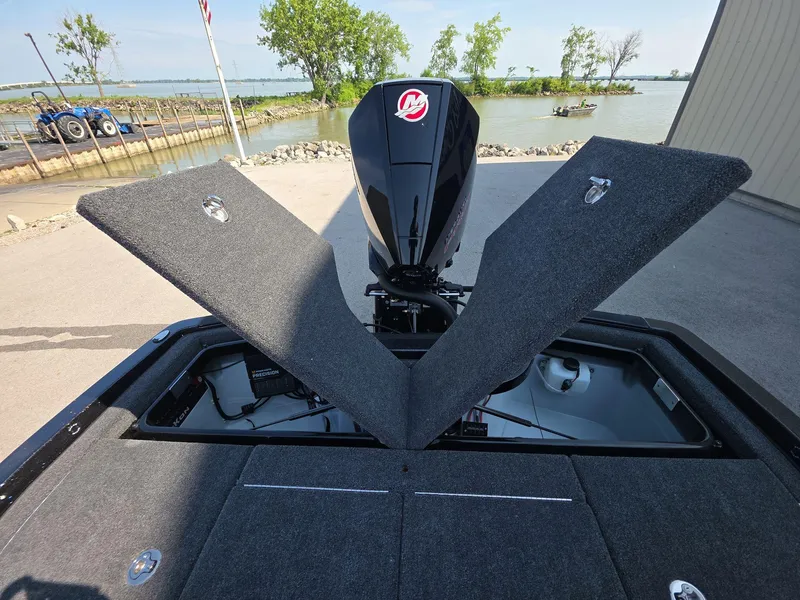 Slide: The Image of 2026 iKon LX21 boat with open storage compartments by a lakeside dock. - 9