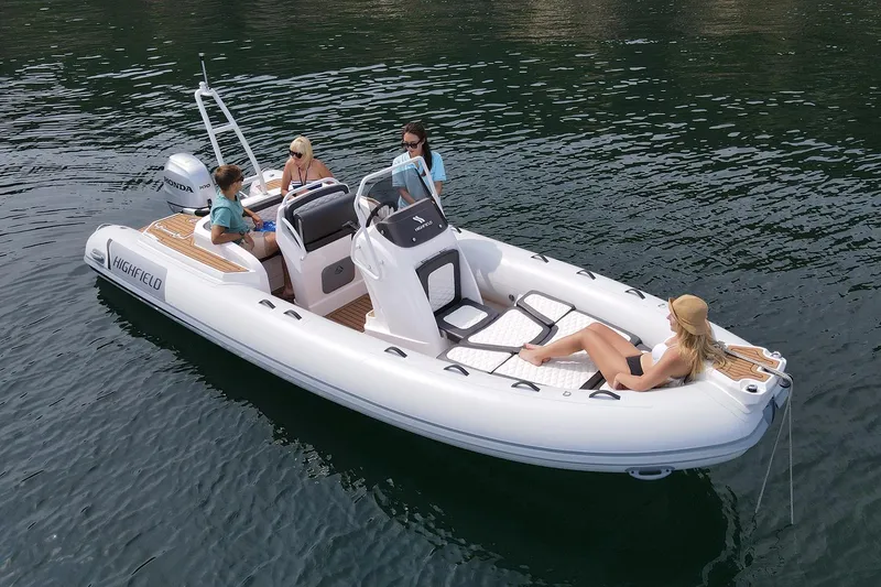 Slide: The Image of 2025 Highfield Sport 650 boat with passengers on calm water. - 1