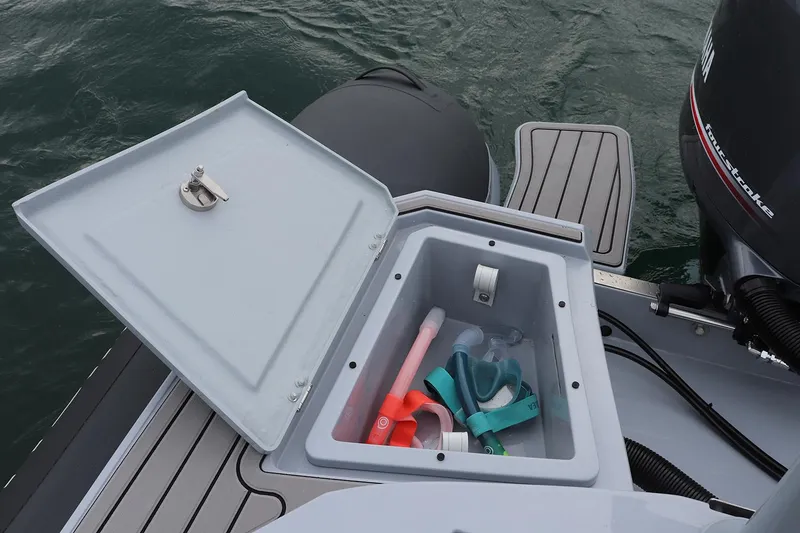 Slide: The Image of Open storage compartment on 2025 Highfield Sport 650 boat with snorkeling gear inside. - 7