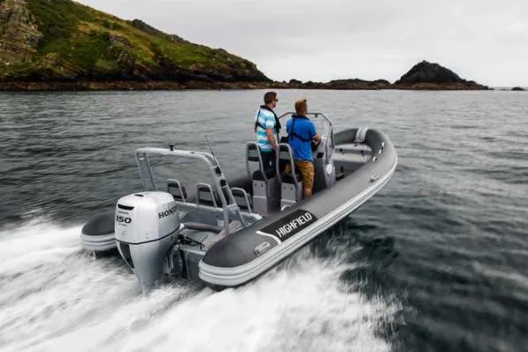 Slide: The Image of 2024 Highfield Patrol 660 boat cruising on open water with two passengers. - 1