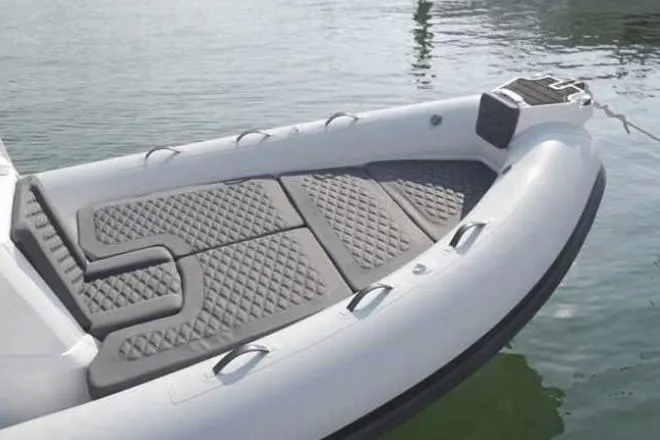 Slide: The Image of 2025 Highfield Sport 660 boat bow with cushioned seating on calm water. - 3