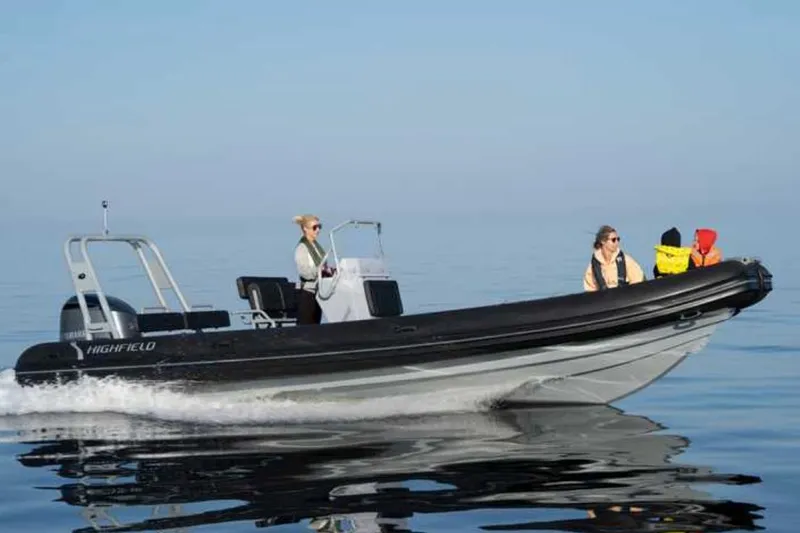 The Image of 2024 Highfield Patrol 700 boat cruising on calm water with passengers onboard. - 0