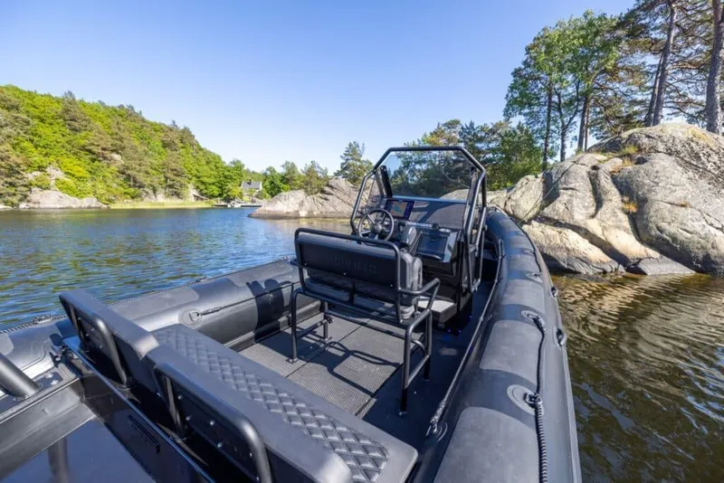 Slide: The Image of Highfield Patrol 700 boat 2026 on calm lake with rocks. - 4