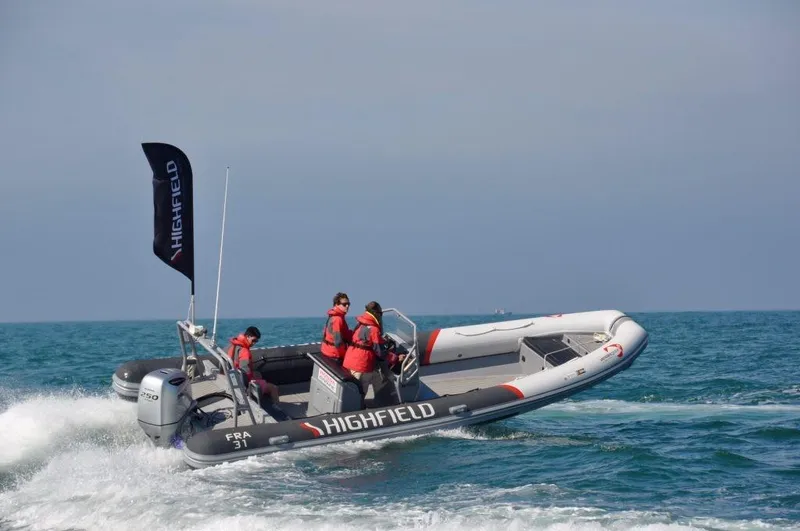 Slide: The Image of 2024 Highfield Patrol 760 boat navigating ocean waves with passengers in life jackets. - 5