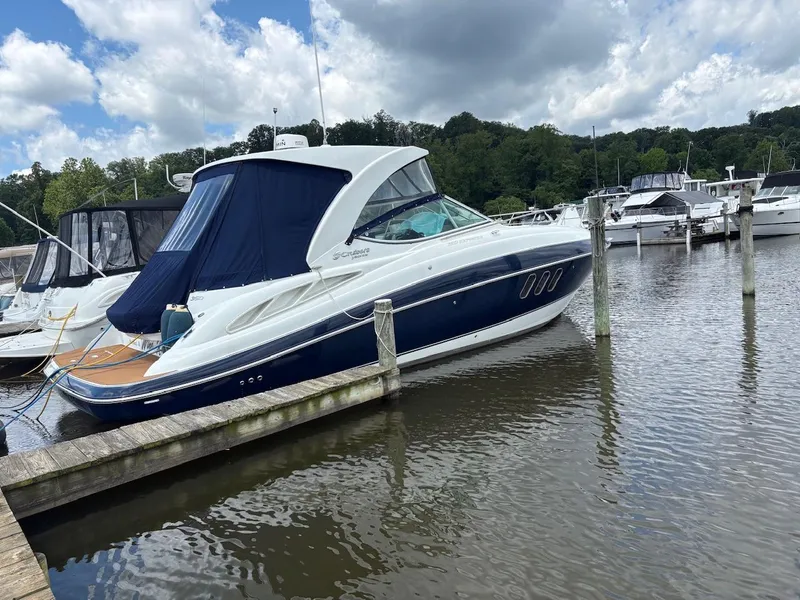 The Image of 2013 Cruisers Yachts 350 Express docked at a marina under cloudy skies. - 0