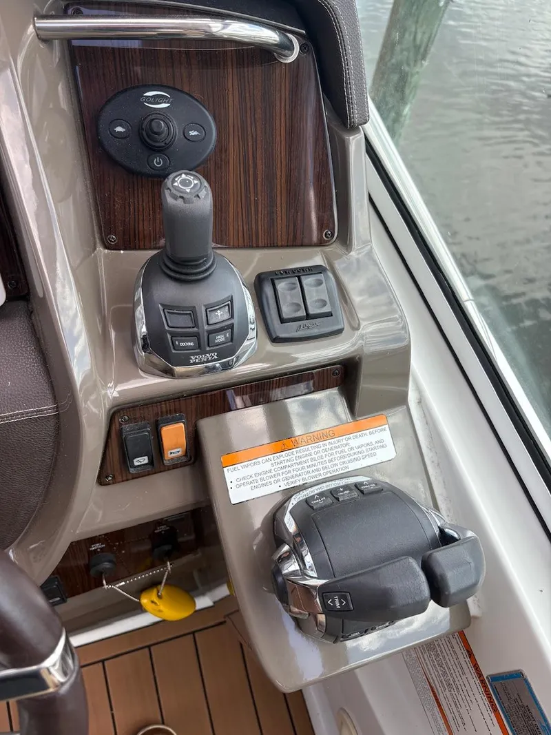 Slide: The Image of Control panel of 2013 Cruisers Yachts 350 Express with joystick and throttle controls. - 12