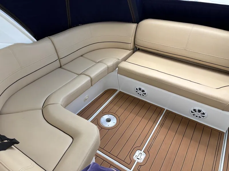 Slide: The Image of 2013 Cruisers Yachts 350 Express interior with beige seating and teak flooring. - 16