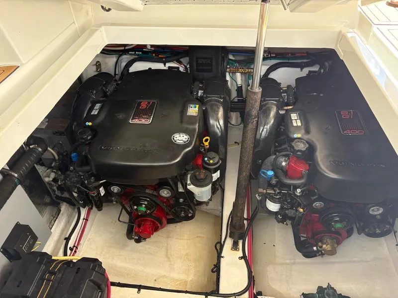 Slide: The Image of Engine compartment of 2013 Cruisers Yachts 350 Express, featuring dual inboard motors. - 19