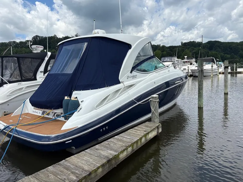 Slide: The Image of 2013 Cruisers Yachts 350 Express docked at marina under cloudy sky. - 2